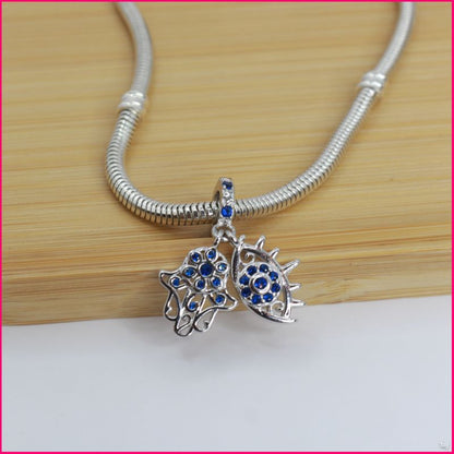 Charm Doble “Mano de Fátima y Ojo Protector”: Un Toque de Elegancia y Protección ✨